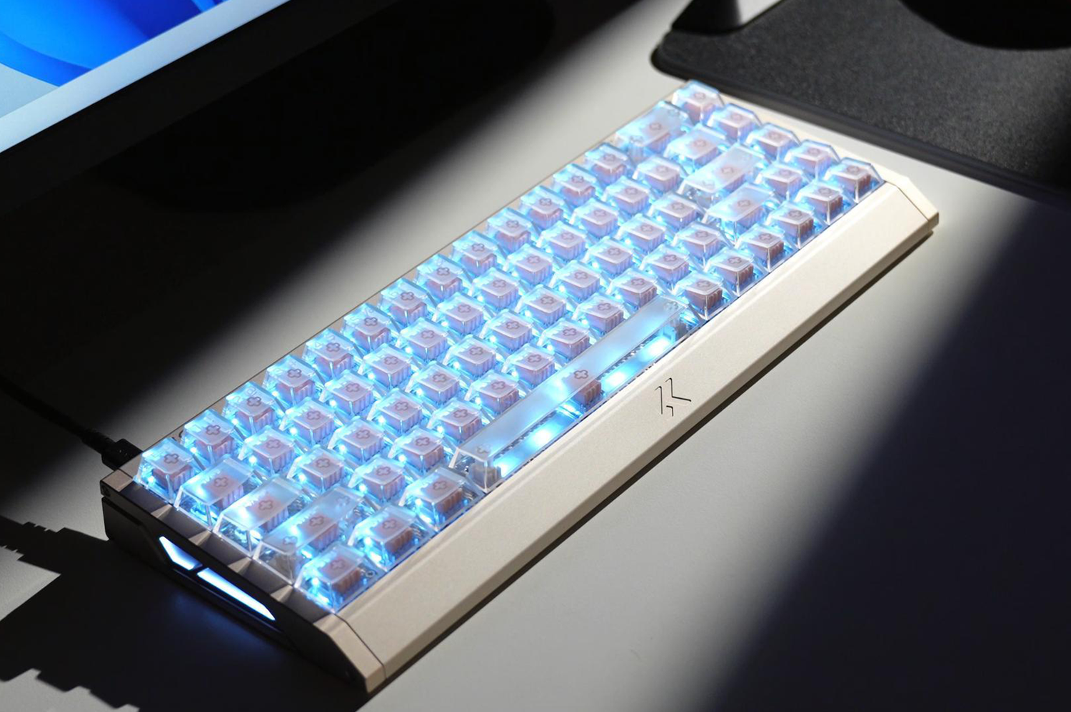 Backlit mechanical keyboard with glowing blue keys and sleek design for gaming or work setup