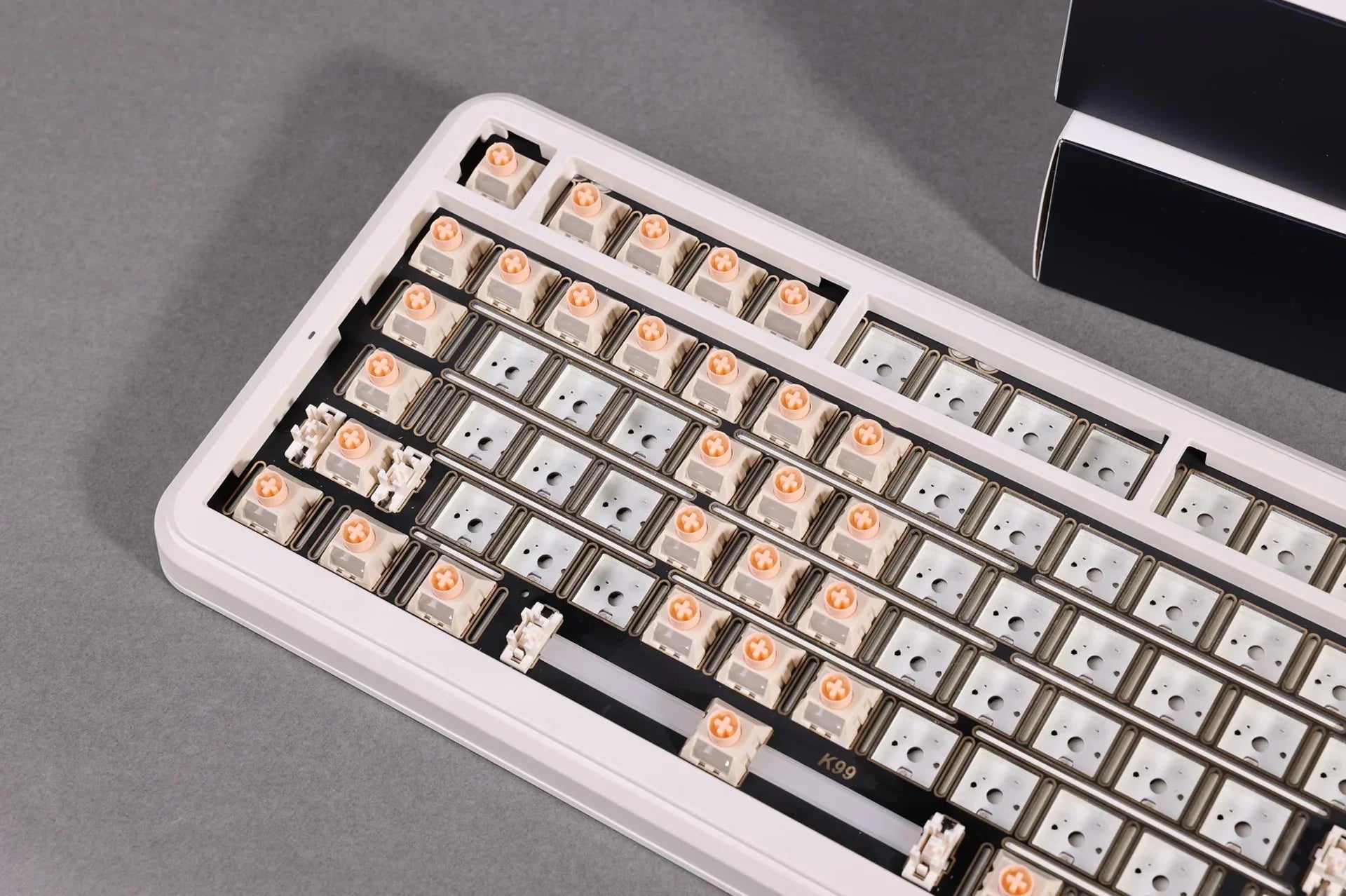 Mechanical keyboard with exposed switches and keycaps, showcasing K99 model design for gaming and typing