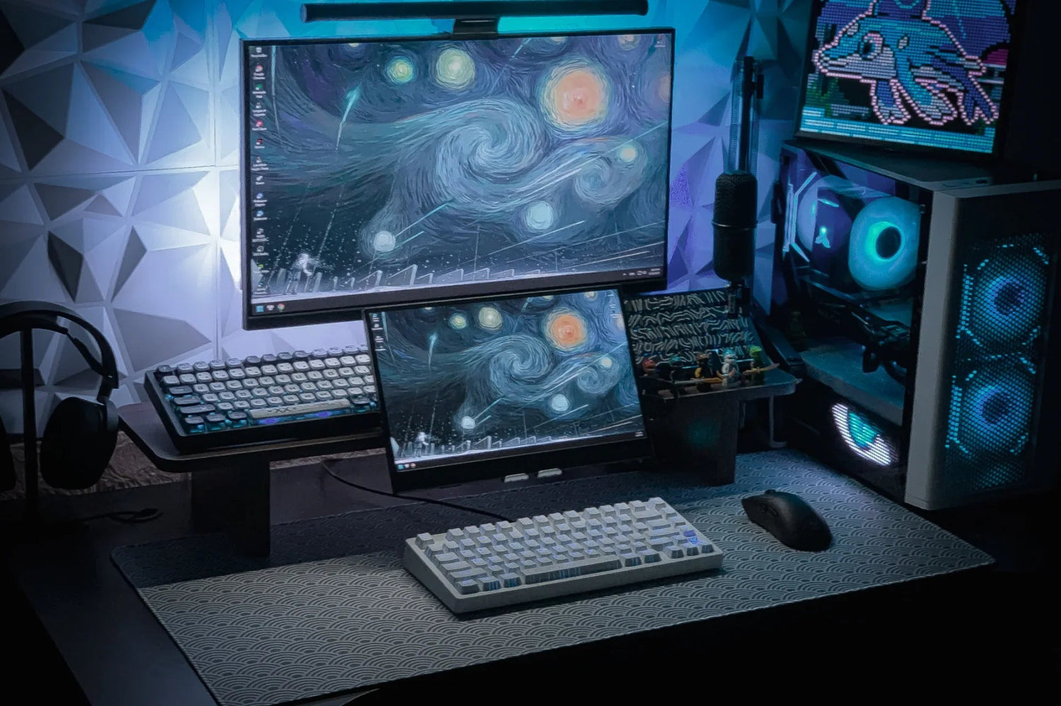 Dual monitor gaming setup with mechanical keyboards, RGB PC, and Starry Night wallpaper