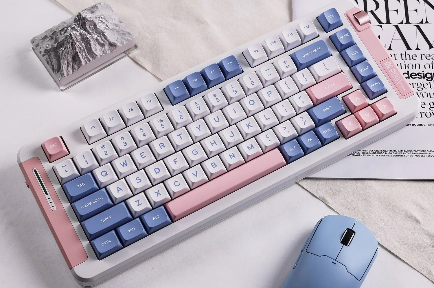 Pastel mechanical keyboard with blue, pink, and white keys, paired with matching mouse on desk setup