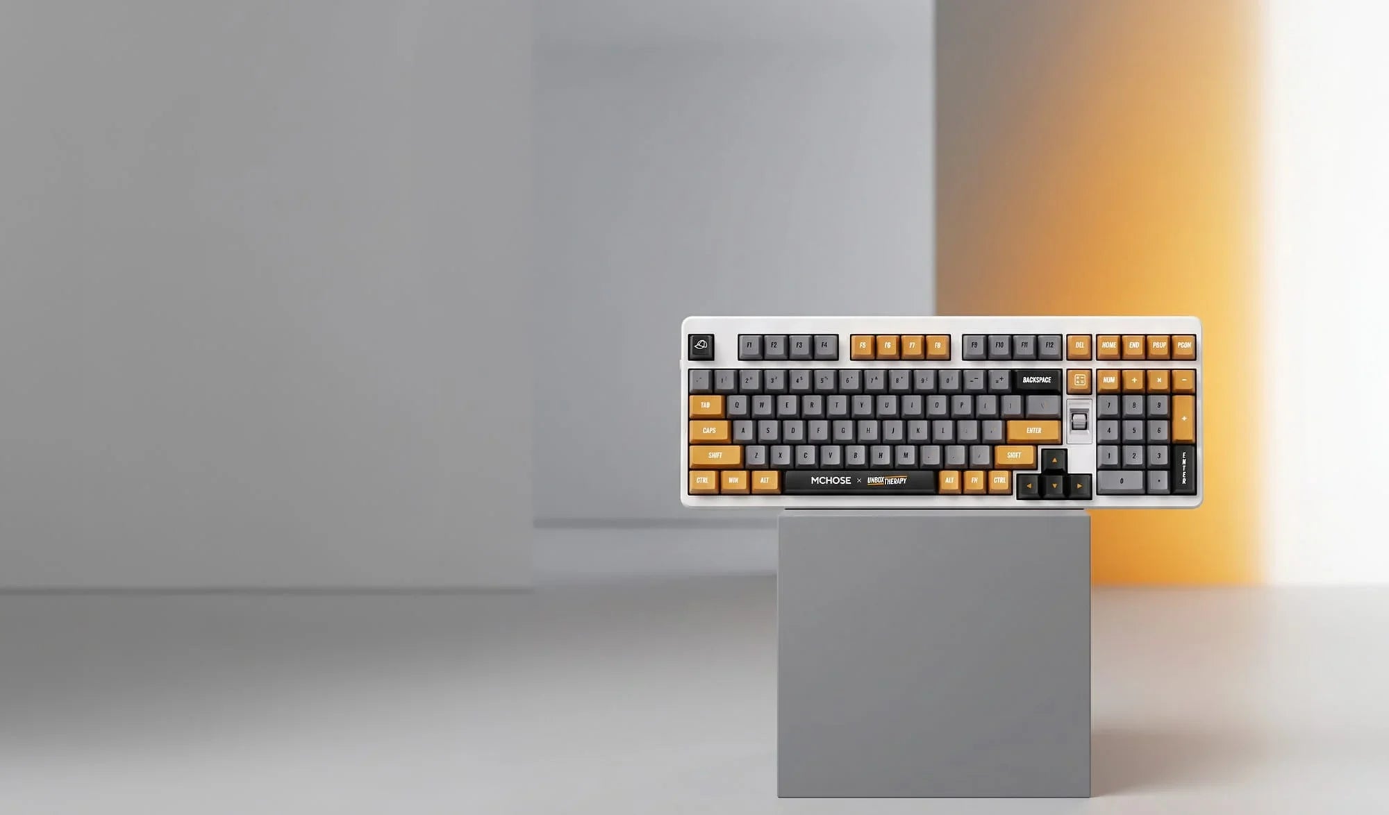 Modern mechanical keyboard with gray and orange keys on display stand, ideal for gaming and productivity.